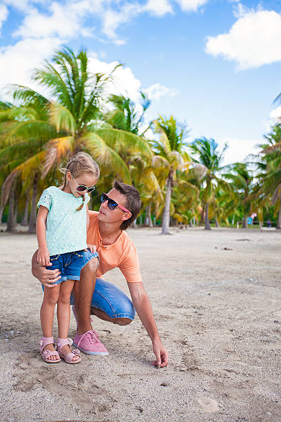istock Young father and his daughter have fun on exotic beach 454255933