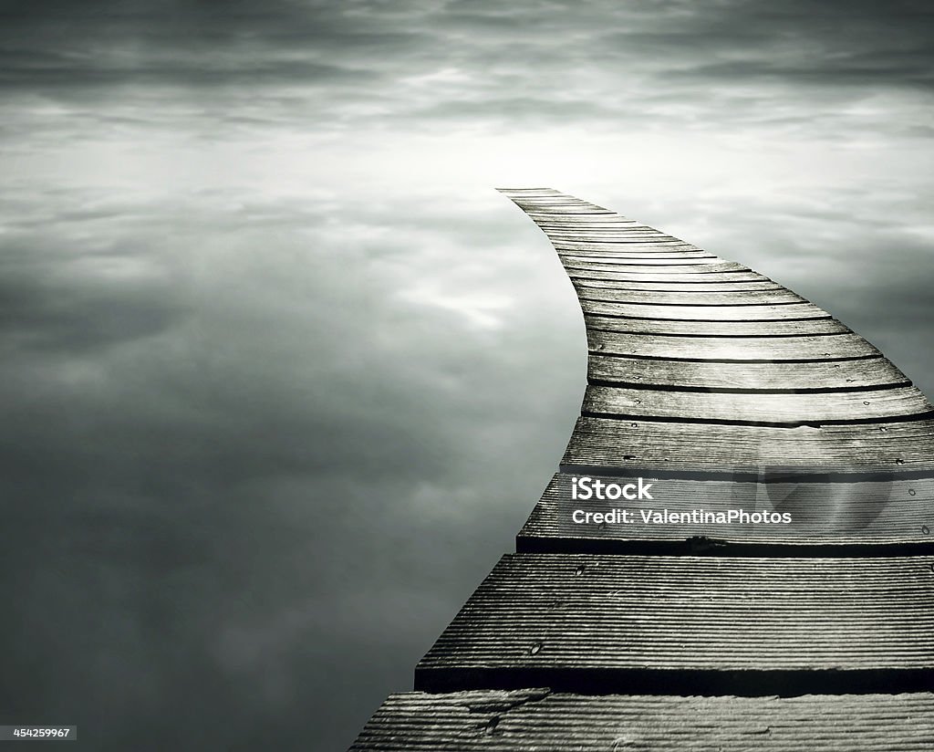 Infinity Beautiful conceptual background with a wooden path in to the infinity dramatic sky Footpath Stock Photo