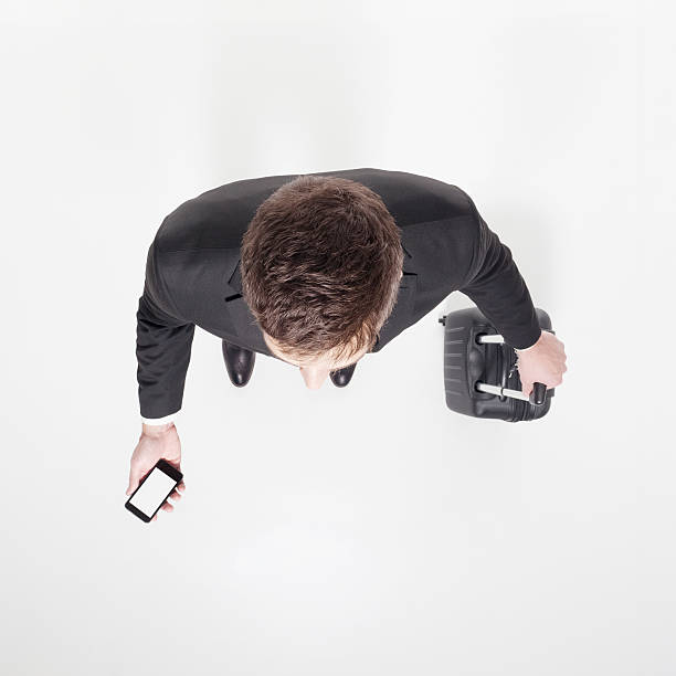 istock Businessman with suitcase and cellphone 454260417
