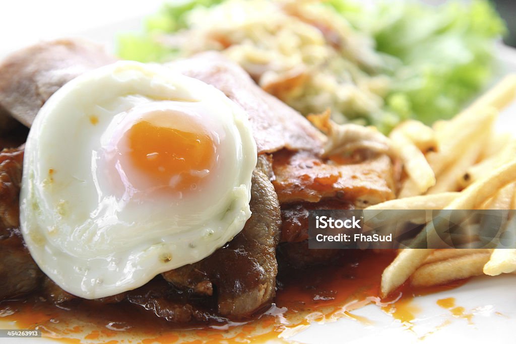 Juicy steak meat with french fries and fried eggs. Beef Stock Photo