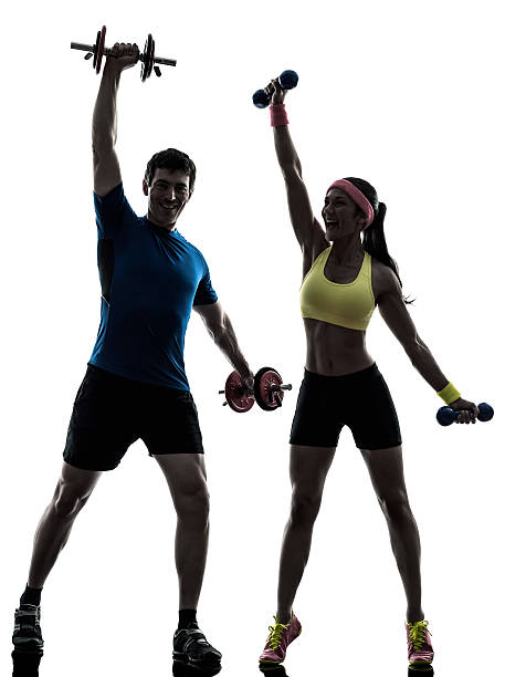woman exercising fitness workout with man coach one woman exercising fitness workout with man coach in silhouette on white background dumbbell silhouette stock pictures, royalty-free photos & images