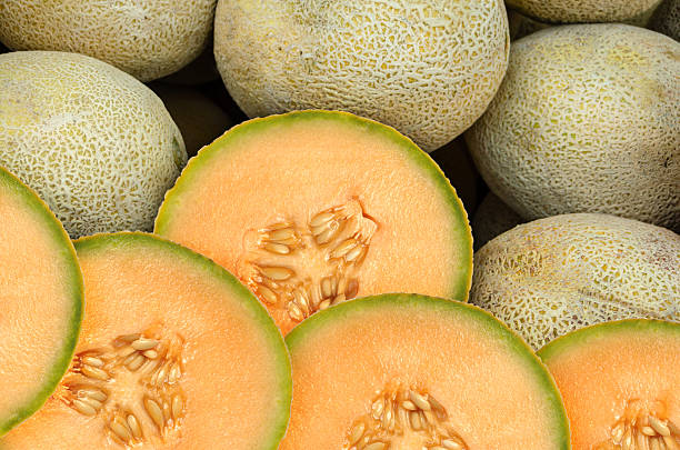 A group shoot of sliced cantaloupe melons Cantaloupe melon pieces on a weekly fruit market melon photos stock pictures, royalty-free photos & images