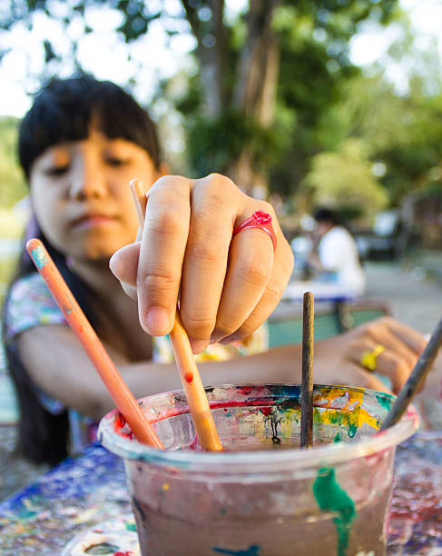 istock Asian girl picking paint brushes 454277397