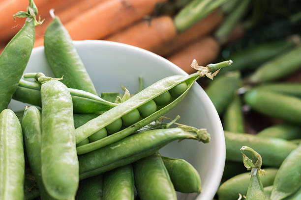 istock Pea pods in a bowl with carrots 454283163