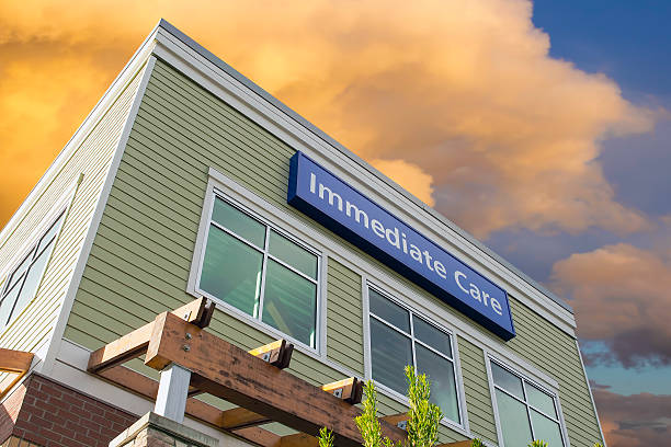 istock Immediate Care Sign On Hospital Building with Clouds 454293053