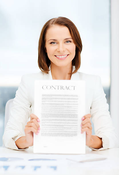 istock happy businesswoman holding contract 454293127