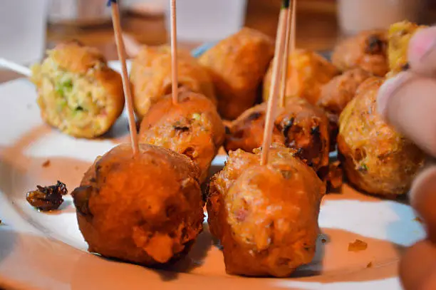 Fried conch fritters - conch meat battered and fried in bite sized balls. Can represent fried foods or finger foods in general