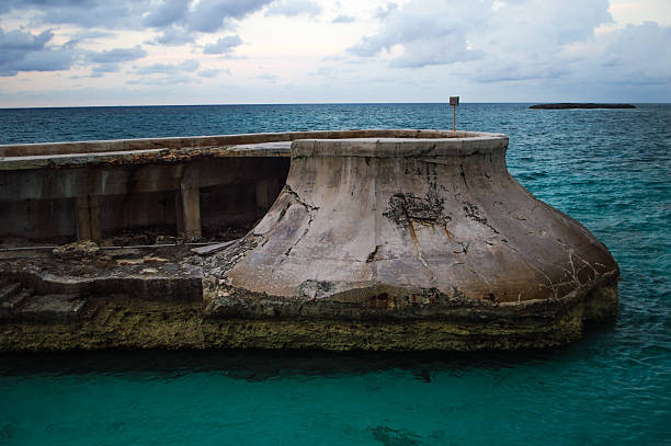 Abandoned concrete ruins in tropical waters stock photo