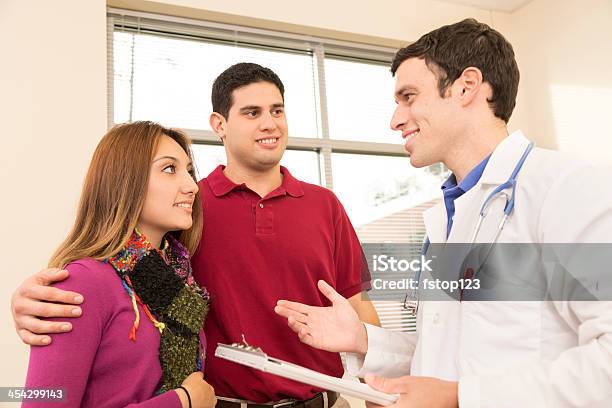 Medical Doctor Discussing Test Results With Patients Young Couple Hospital Stock Photo - Download Image Now