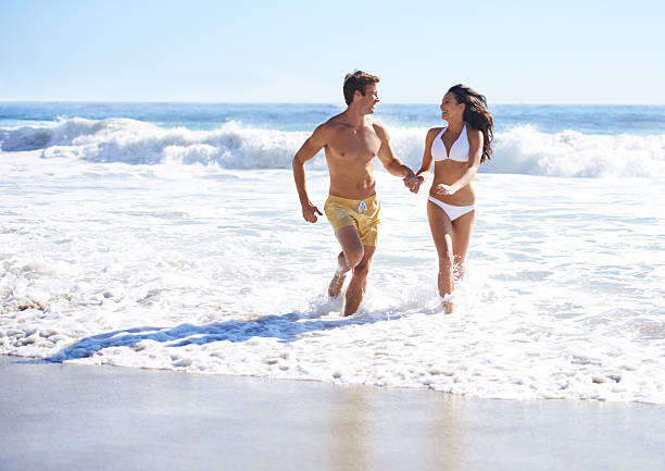 in un mondo di loro - men beach running shirtless foto e immagini stock