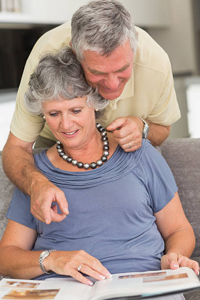 istock Mature man showing something on book to his wife 454300529