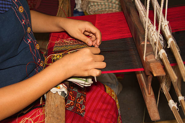 istock Women weaving a cloth  in Chiang Mai 454305425