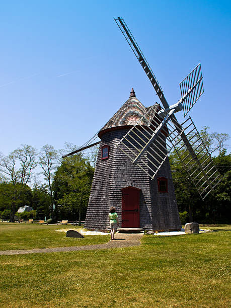 istock Woman Looks at Eastham Windmill in Cape Cod 454307311