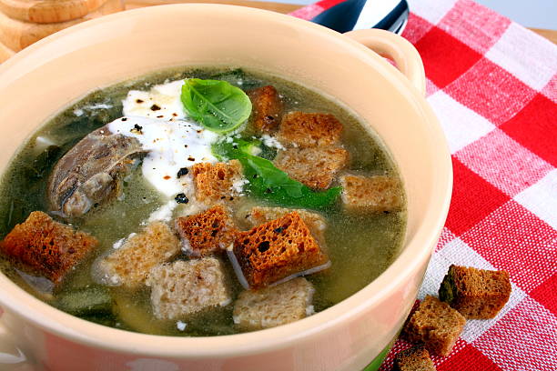 istock Green soup with meat, egg, cream and croutons 454311769