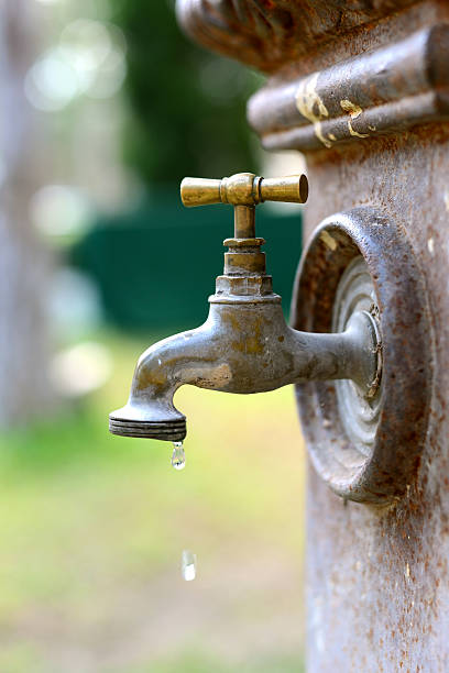 istock Old Brass faucet with drop of water 454312611