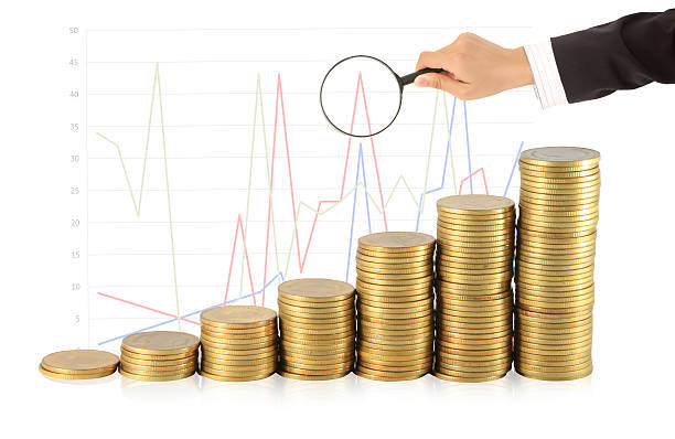 istock Magnifying glass and lots of gold coins 454314901