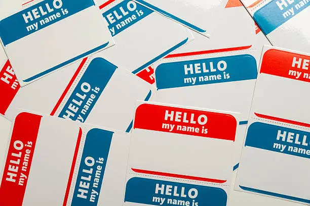 A stack of blue and red "Hello, my name is" name tags or badges