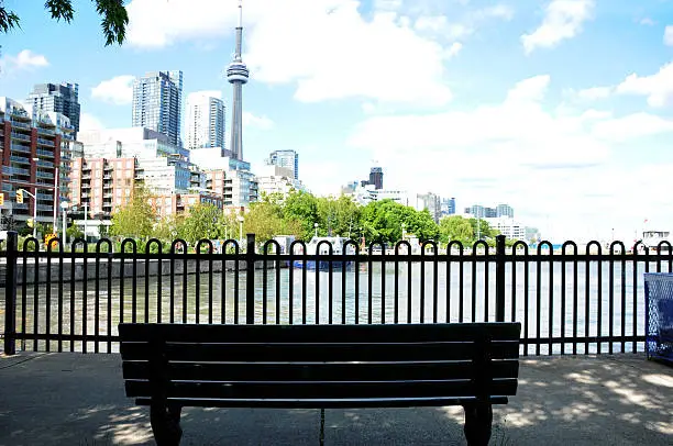 park bench overlooking a panoramic view of the city of Toronto and its lake