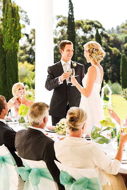 istock Bride And Groom Toasting Champagne Flutes During Reception 454316823