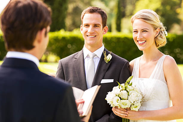 istock Couple Looking At Minister During Wedding Ceremony 454316841