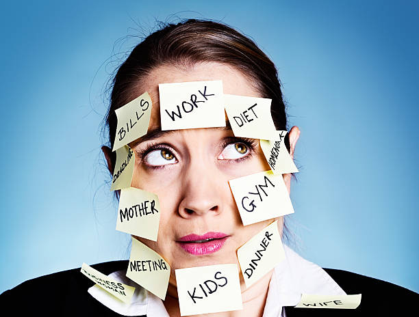 istock Woman covered in  task reminders rolls her eyes sadly 454317929