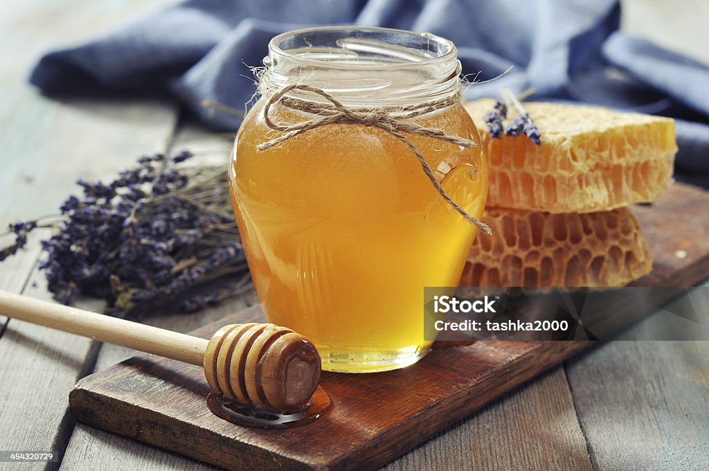 Honey in jar Honey in jar with honey dipper on vintage wooden background Honey Stock Photo Honey in jar Honey in jar with honey dipper on vintage wooden background Honey Stock Photo
