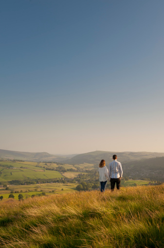 couple looking over a valley to hills beyond