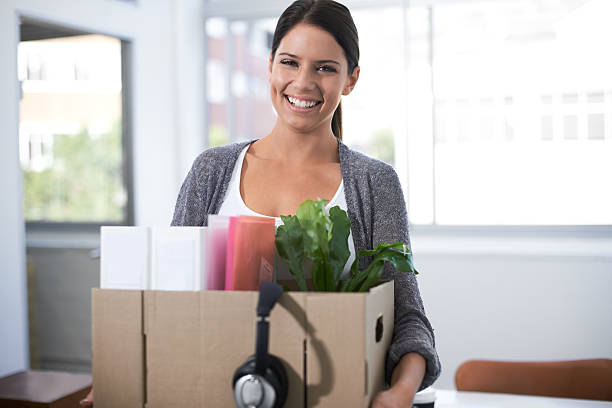 Pleased with her climb up the ladder of success Portrait of an attractive young woman moving into a new office day 1 stock pictures, royalty-free photos & images