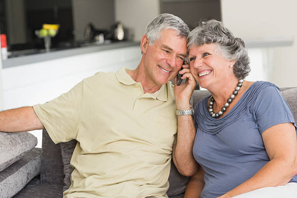 istock Mature couple calling together with their mobile phone 454325681