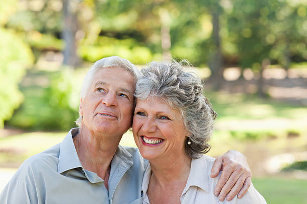 istock Husband hugging his wife and looks at sky 454329689