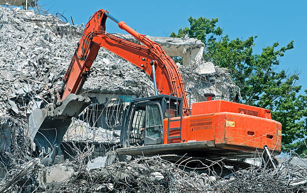 istock Crane with shovel separating concrete from metal at demolition site 454332263