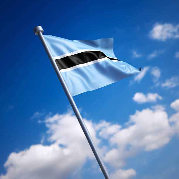 Flag of the Republic of Botswana on modern metal flagpole. Shallow depth of field and motion blur 3d render.