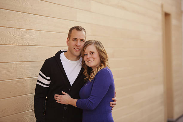 istock Couple Standing by Brick Wall Outside 454334819