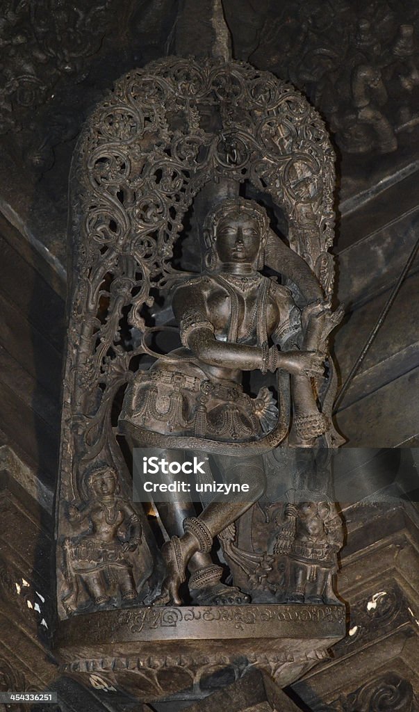 Sculpture on the Wall of an Ancient Temple Sculpture on the Wall of an Ancient Temple called Belur Halebidu. Its located in Karnataka state of India. Ancient Stock Photo