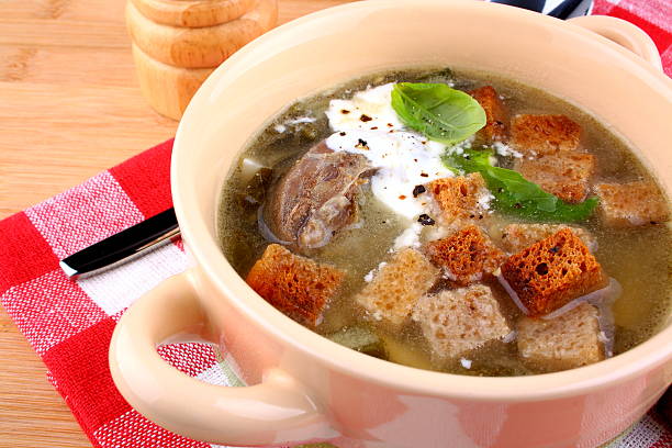 istock Green soup with meat, egg, croutons and cream 454336469