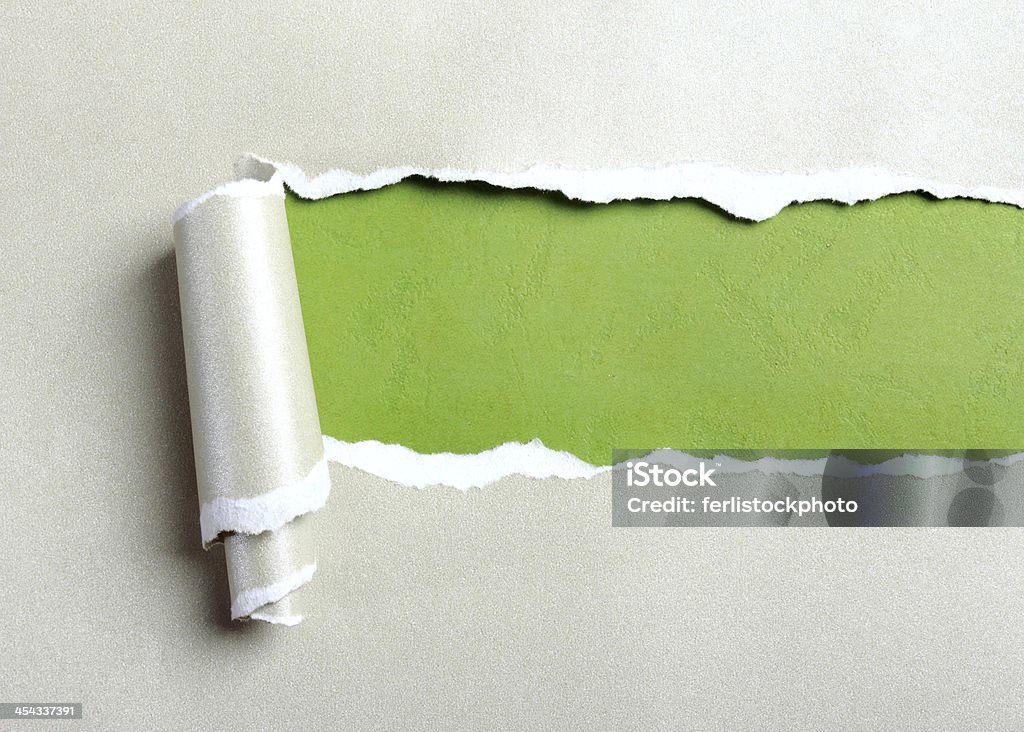 Ripped gray paper Ripped gray paper over green paper background Wrapping Paper Stock Photo