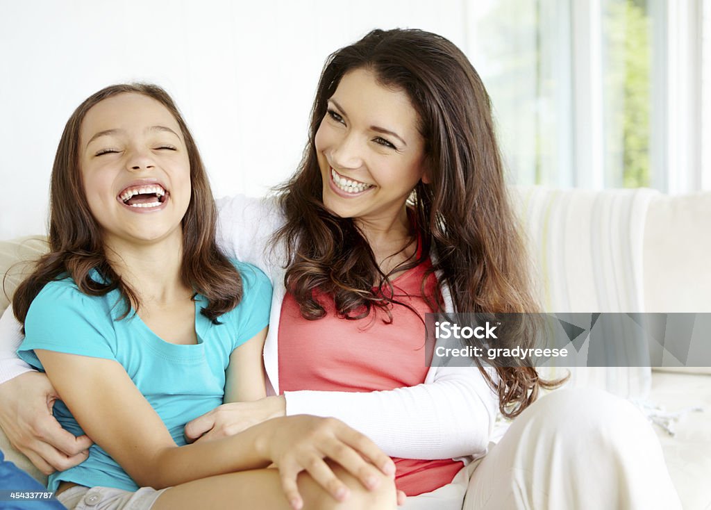 I love spending time with mom A mother tickling her daughter while her daughter laughs heartily 10-11 Years Stock Photo