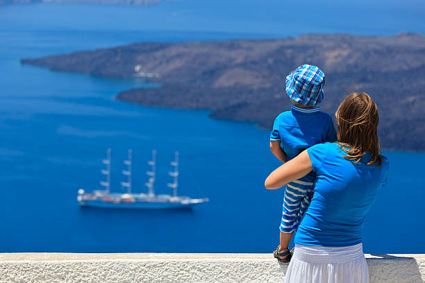 istock family looking at Santorini, Greece 454339045