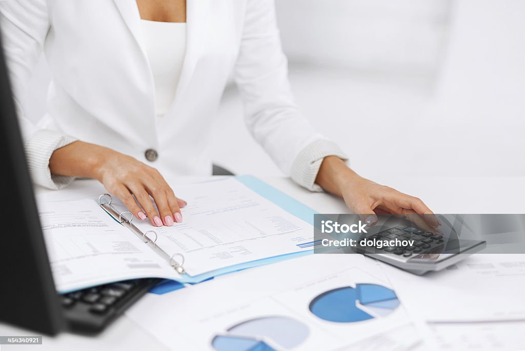 woman hand with calculator and papers business, office, tax, school and education concept - woman hand with calculator and papers Adult Stock Photo