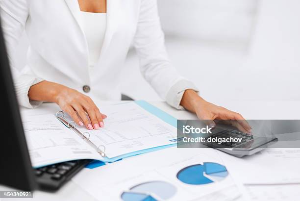 Woman Hand With Calculator And Papers Stock Photo - Download Image Now - Adult, Analyzing, Banking