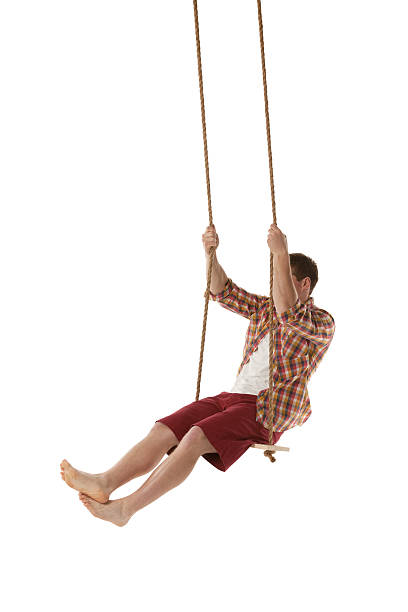 istock Young man swinging on swing rope 454345069
