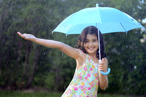 jovem garota desfrutando a chuva - wet dress rain clothing - fotografias e filmes do acervo