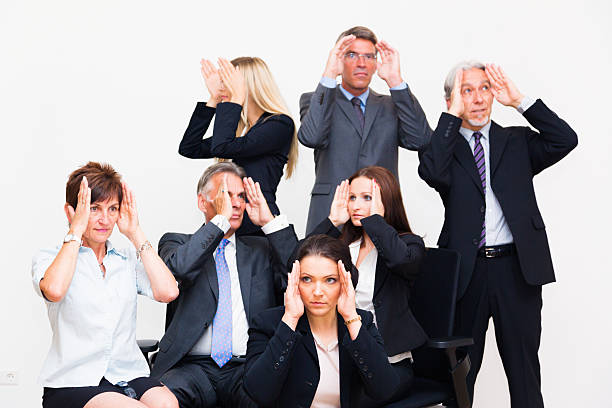 istock blinkered business team looking in different directions 454347393