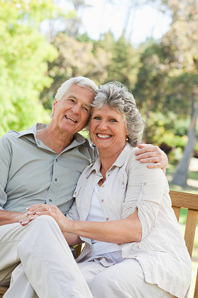 istock Husband and wife embracing while sitting on a bench 454354115