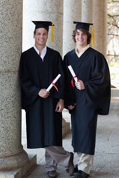 istock Two graduates males holding their diploma 454354267