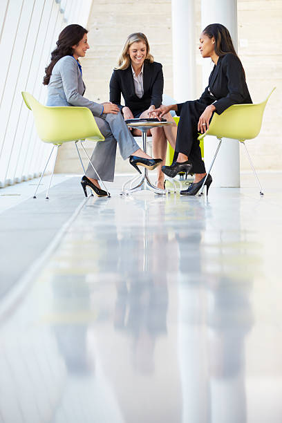 istock Three Businesswomen Meeting Around Table In Modern Office 454355529