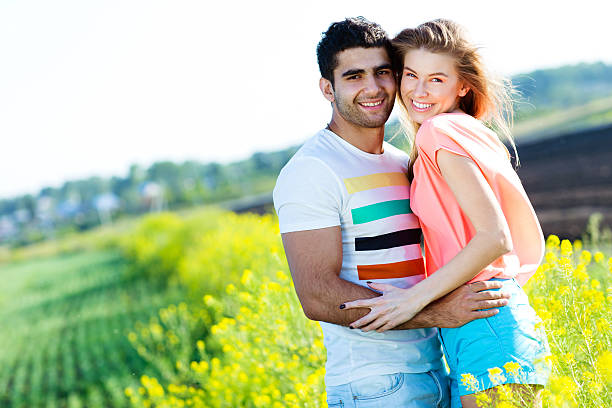 istock Romantic young couple in a field 454355681