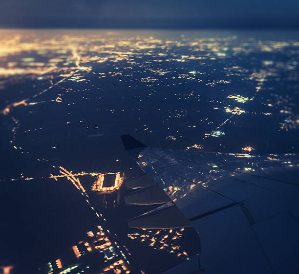 istock airplane wing over a city illuminated 454358389
