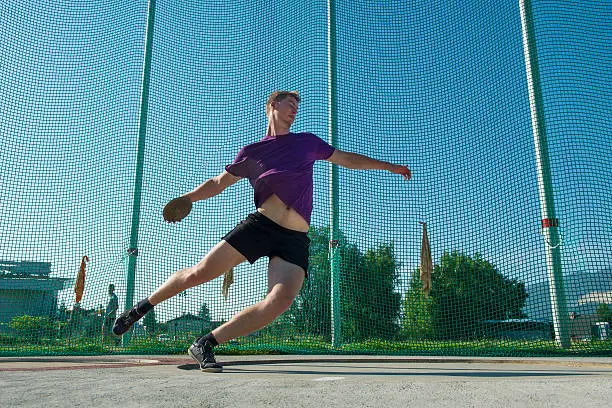 Side view of young man throwing the disckus