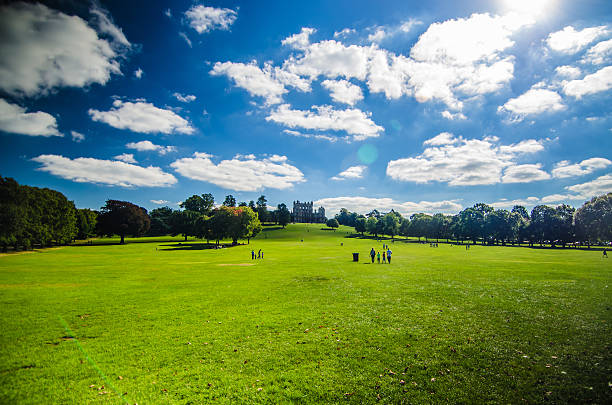 People walking at Wollaton Hall on a sunny day